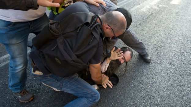 Police arrest an ultra-Orthodox Jew after he attacked people with a knife during a Gay Pride parade Thursday, July 30, 2015