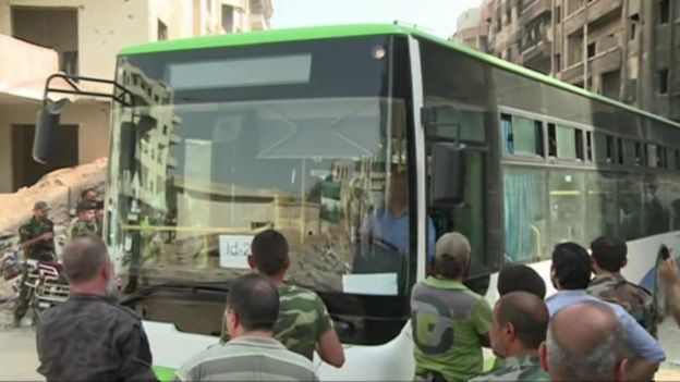 A bus evacuating people from the besieged Syrian town of Darayya leaves