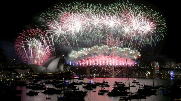 Fireworks explode over the Sydney Opera House and Harbour Bridge as Australia