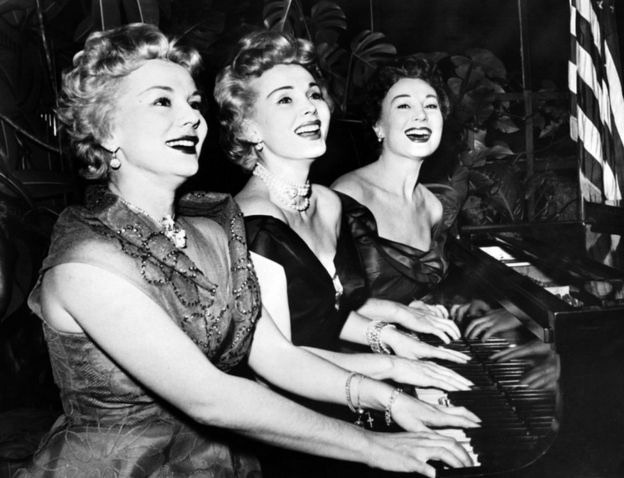 This file photo from January 1954 shows US actress Zsa Zsa Gabor (C) and her sisters Eva (L) and Magda, playing piano for new year day.