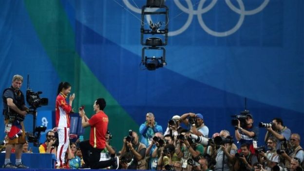 He Zi (CHN) of China recieves a marriage proposal from Olympic diver Qin Kai (CHN) of China after the medal ceremony