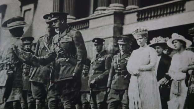 Darwan Singh Negi receives the Victoria Cross from King George V as Queen Mary looks on in Locon, France (1914)