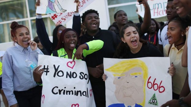 Jóvenes con carteles contra Trump: 