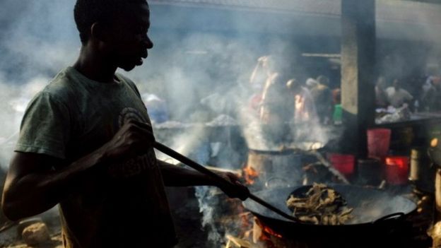Mohammed Ismael cooks fish market at a stall on 27 September 2013 in Dar es Salaam