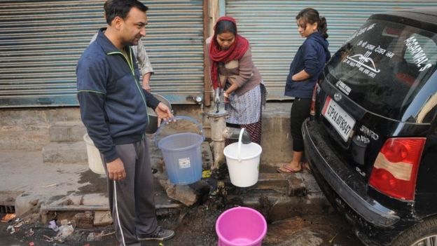 Indian children collect water from the hand pump, a ground water source of water, in the Azadpur area of north Delhi, India, 22 February 2016