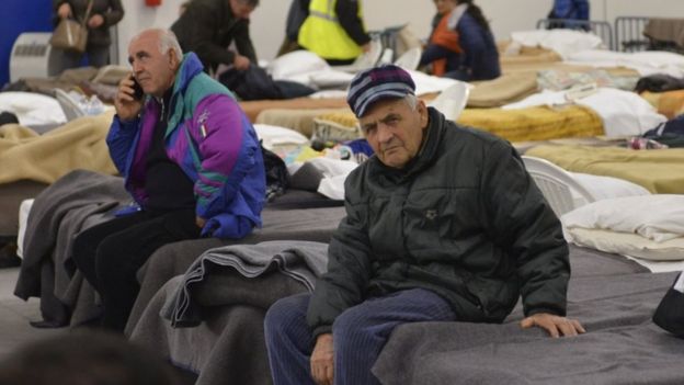 Locals in Italy prepare to spend the night in a warehouse after a powerful earthquake hit