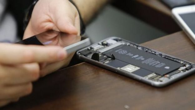 A worker checks an iPhone, file picture