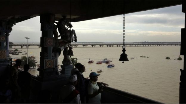 Indian officials look at the swollen river Ganges in Allahabad, India, Friday, Aug. 19, 2016