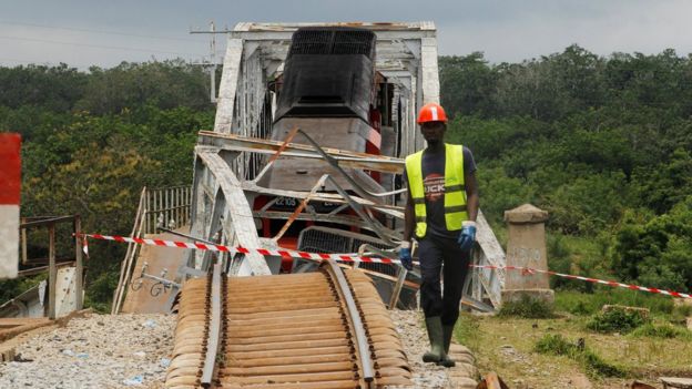 A worker walks next to a partially collapsed railroad bridge over the River Nzi, near Dimbokro, Ivory Coast - Thursday 8 September 2016