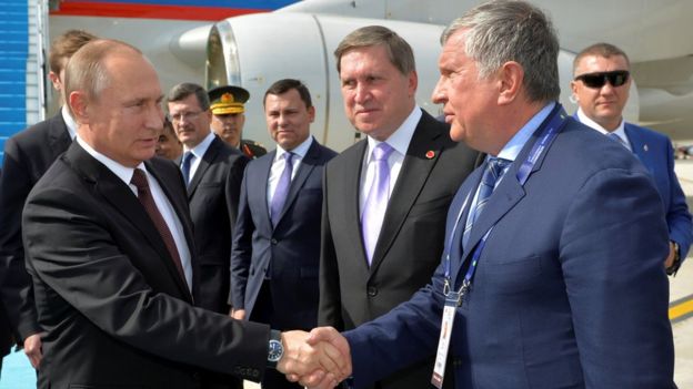 Russian President Vladimir Putin shakes hands with head of Russia's top oil producer Rosneft, Igor Sechin as he arrives at Ataturk airport in Istanbul, Turkey, October 10, 2016