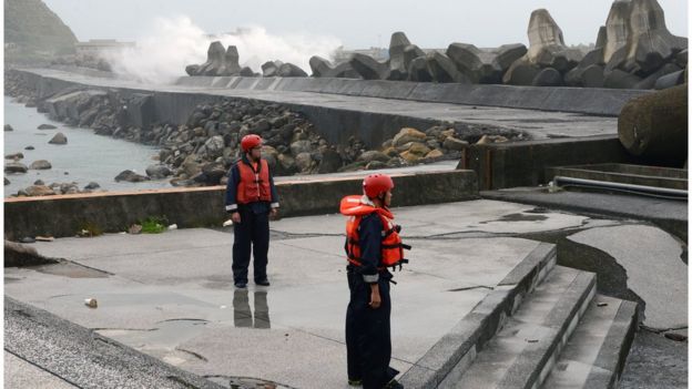 Taiwanese coast guards keep watch on the coastline of Keelungas typhoon Dujuan approaches