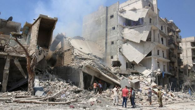 Men inspect a damaged site after double airstrikes on the rebel held Bab al-Nairab neighborhood of Aleppo on 27 August