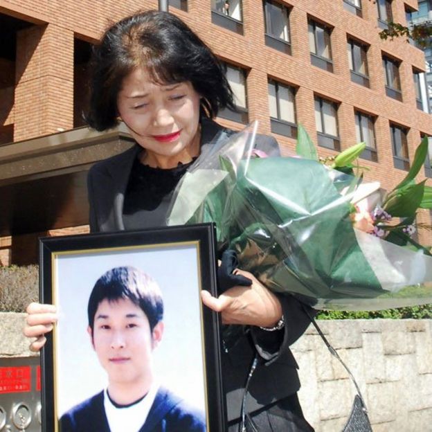 Fujie Sugiyama sostienen la foto de su hijo Takanori, declarado víctimas de karoshi en 2007