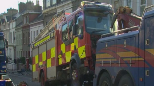 The fire engine is towed away