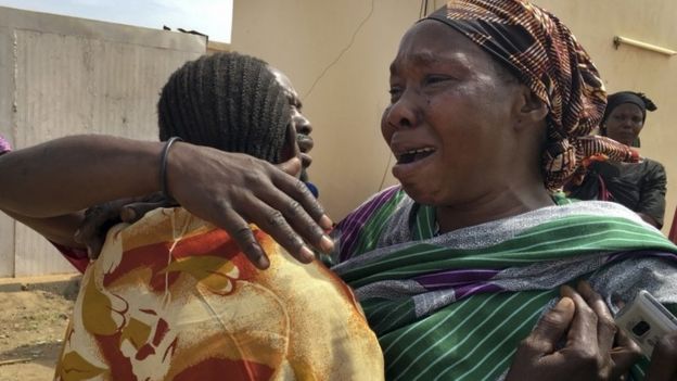 Grieving relatives of killed aid workers at Juba morgue