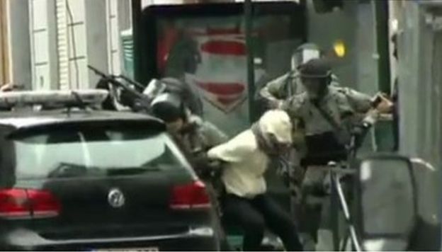 The moment Salah Abdeslam is bundled into a police car following his capture