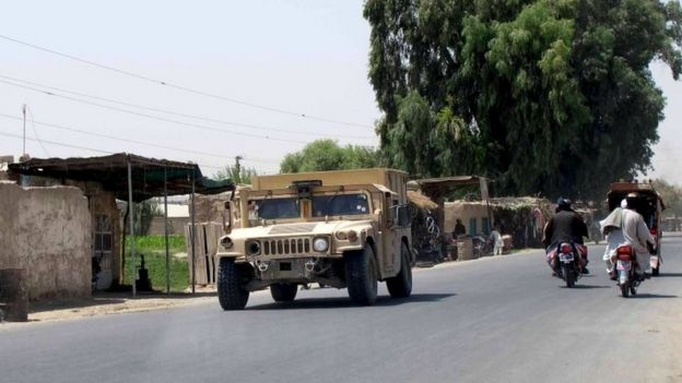 An Afghan National Police armoured vehicle patrols on a street in Lashkar Gah capital of Helmand province (26 August 2015)