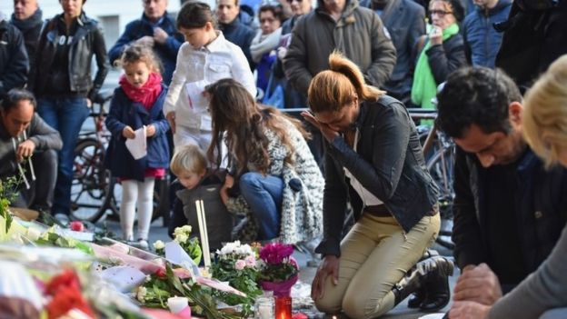 The public lay flowers outside of the La Belle Equipe restaurant on Rue de Charonne following Fridays terrorist attack
