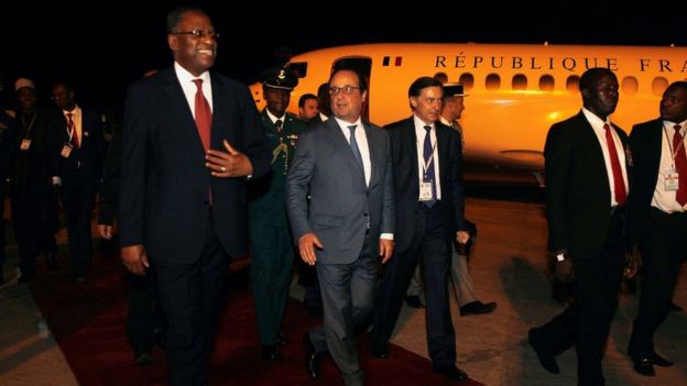 French President Francois Hollande (C) is received by Nigerian Foreign Minister Geoffrey Onyeama (L) on arrival in Abuja, Nigeria, 13 May