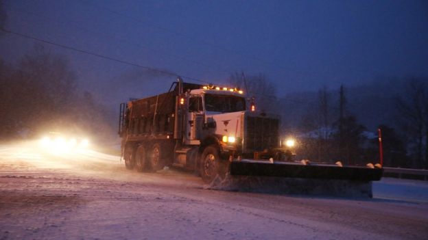 A large truck ploughing snow
