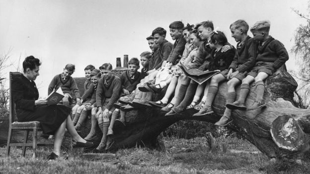 Una maestra lee a un grupo de niños en Stevenage, Inglaterra