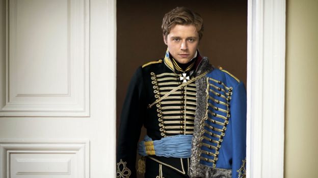 Nikolai Rostov (Jack Lowden) shows how to wear the Hussar's pelisse correctly, over the left shoulder (BBC)