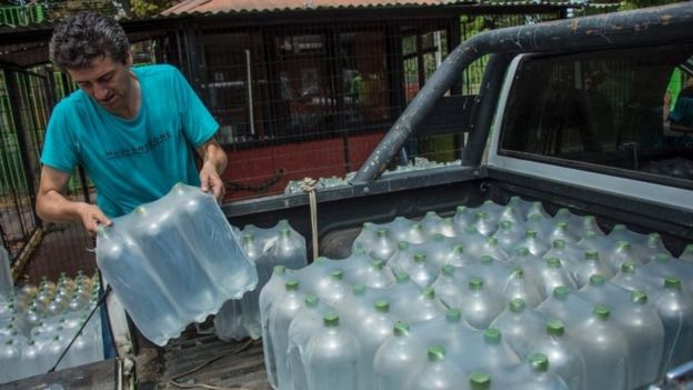 People get water during a drinking water supply cut in Santiago, on February 26, 2017. M