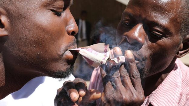 Protesters smoking Zimbabwe's old bond notes in Harare - - Wednesday 3 August 2016