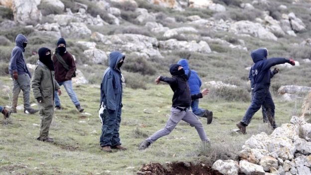 Protesters throw stones during an operation to evacuate the unauthorised settlement outpost of Amona in the occupied West Bank (1 February 2017)