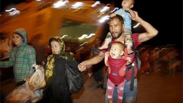 Migrants leave a passenger ship in Athens, 8 September 2015