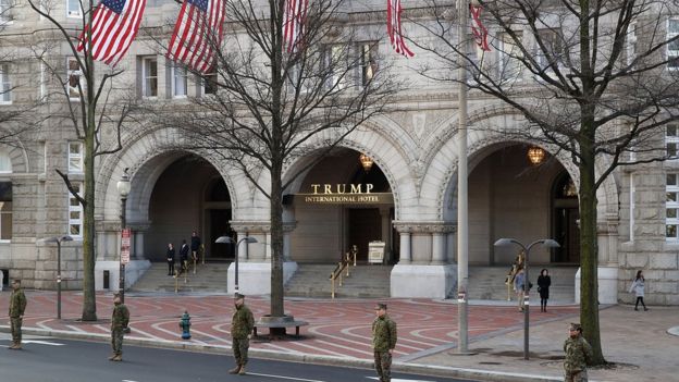 Members of the US military stand in front of the Trump International Hotel on Pennsylvania Avenue in Washington, DC.