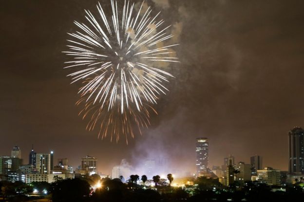 Fireworks illuminate the night sky over the Kenyatta International Convention Centre (KICC) during New Year