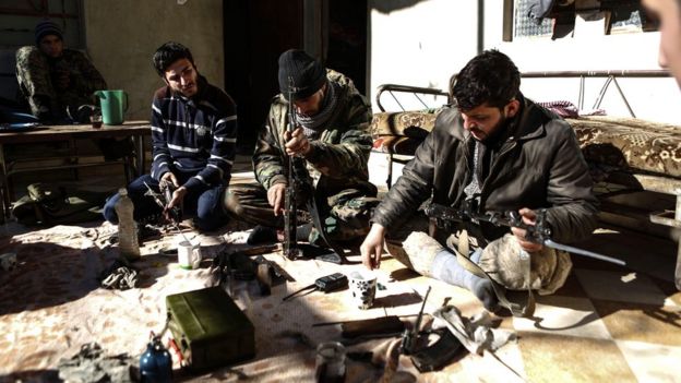 Rebel fighters clean their weapons in rebel-held Douma, on the outskirts of Damascus, Syria (15 December 2016)