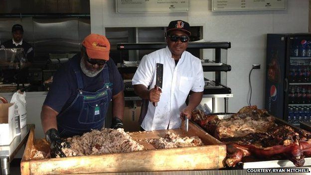 Ed and Ryan Mitchell chopping pork at the Durham baseball stadium