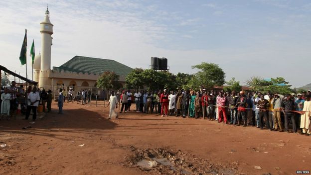 People gather at the site of the blast at Nyanya