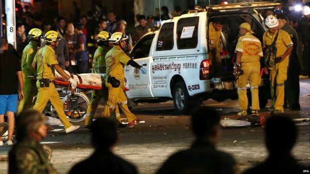 Thai rescue workers carry body of bomb victim after an explosion outside Erawan Shrine in central of Bangkok, Thailand - 17 August 2015