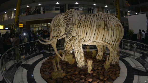 People look at a life-size ivory elephant sculpture after it was unveiled at the Sir Seretse Khama International Airport in Gaborone, Botswana [photo released on 17 July 2015)