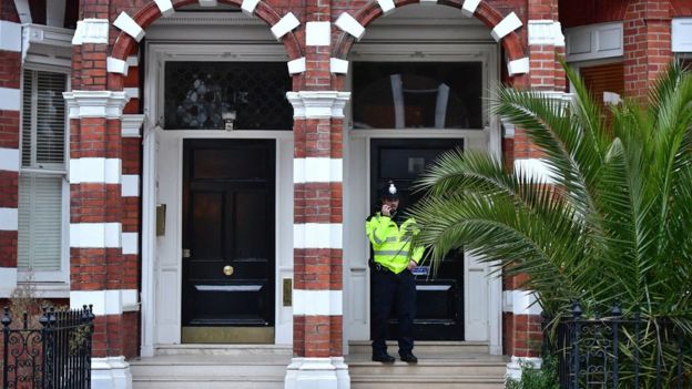 A police officer outside the flat where Palmer-Tomkinson's body was found