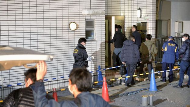 Police officers arrive for investigation of the apartment of abduction suspect Kabu Terauchi in Tokyo Monday, March 28, 2016