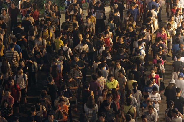 Nine lines of people queue at a polling station to vote for the legislative council election Sunday, Sept. 4, 2016.