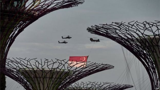 Helicopters flying over Gardens by the Bay carrying the Singapore flag in a parade rehearsal (1 Aug 2015)