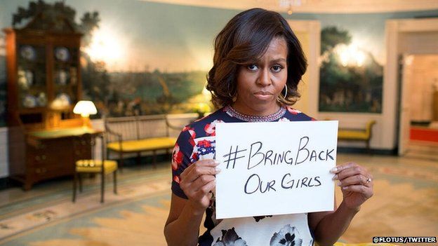Michelle Obama holding a sign reading: "#Bring Back Our Girls"