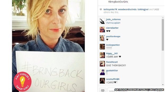 Amy Poehler holding a sign reading: "#Bring Back Our Girls"