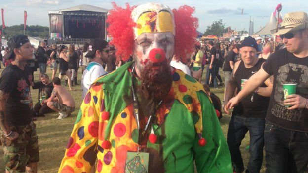 A man dressed as an evil clown