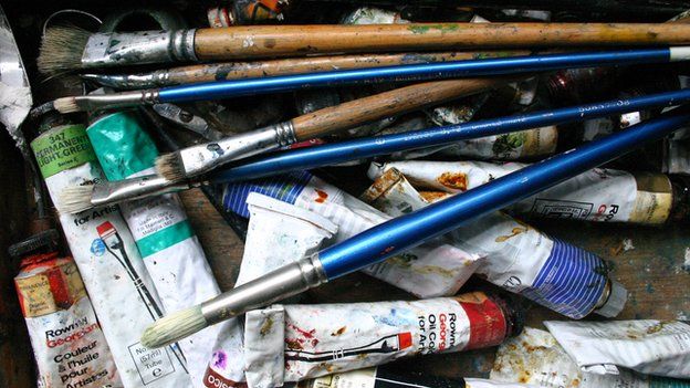Tubes of paint and brushes