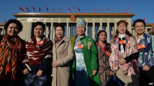 Chinese Uighur delegates from Xinjiang province arrive for the first session of the National People's Congress (NPC) at the Great Hall of the People in Beijing on 5 March 2014