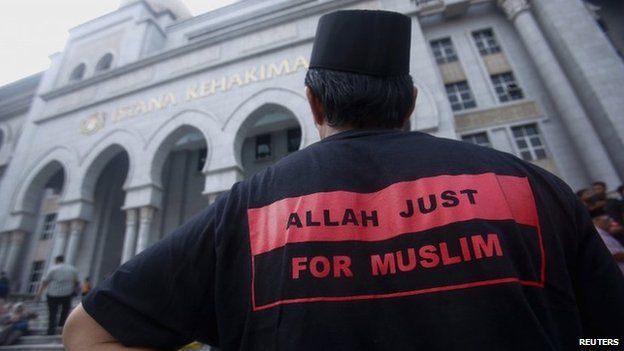 A Muslim man stands outside the court in Putrajaya outside Kuala Lumpur on 23 June 2014