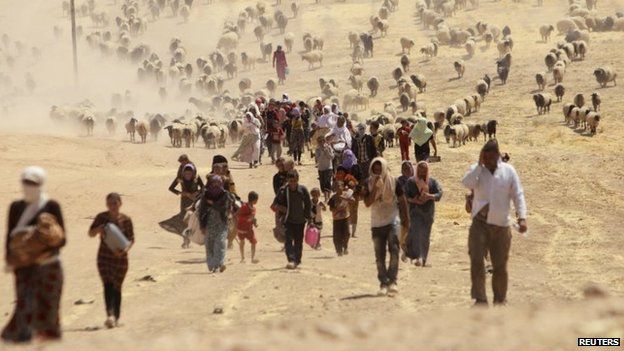 Displaced Iraqis from the Yazidi religious minority flee Islamic State fighters by walking towards the Syrian border (11 August 2014)
