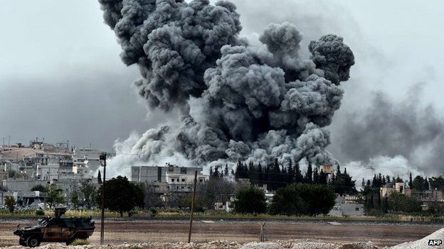 Smoke rises after an air strike on an Islamic State position in the Syrian town of Kobane (12 October 2014)