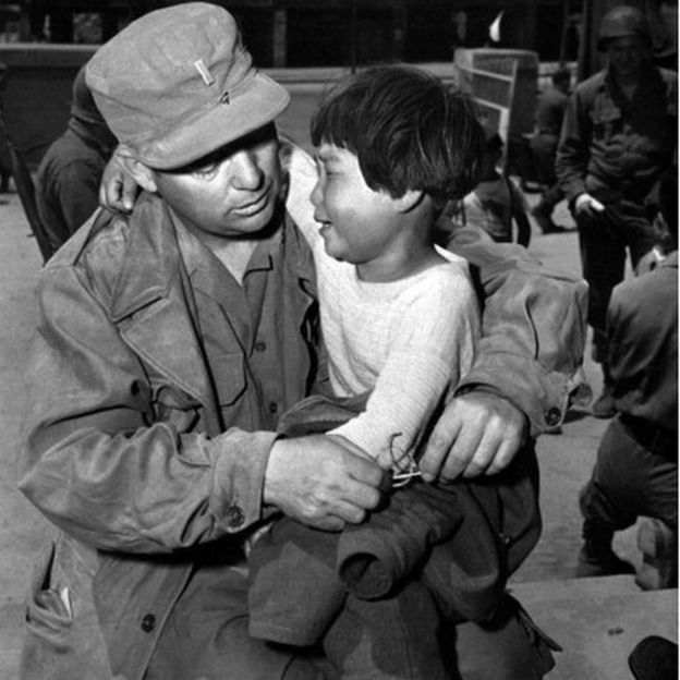 A picture dated May 23, 1951 shows a Korean orphan little girl crying in the arms of US lieutenant William Doernbach during Korean War. Doernabach had found her abandoned in her village in winter